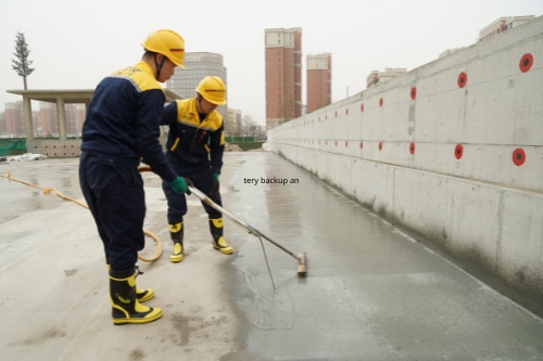 Worker applying waterproofing layer on a floor surface
