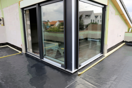 Waterproofing being applied to a balcony surface to prevent water damage