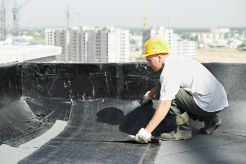 Waterproofing treatment being applied to a roof to prevent leaks and water damage