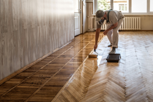 Wooden floor installation in progress, showcasing natural wood planks for a warm and timeless look